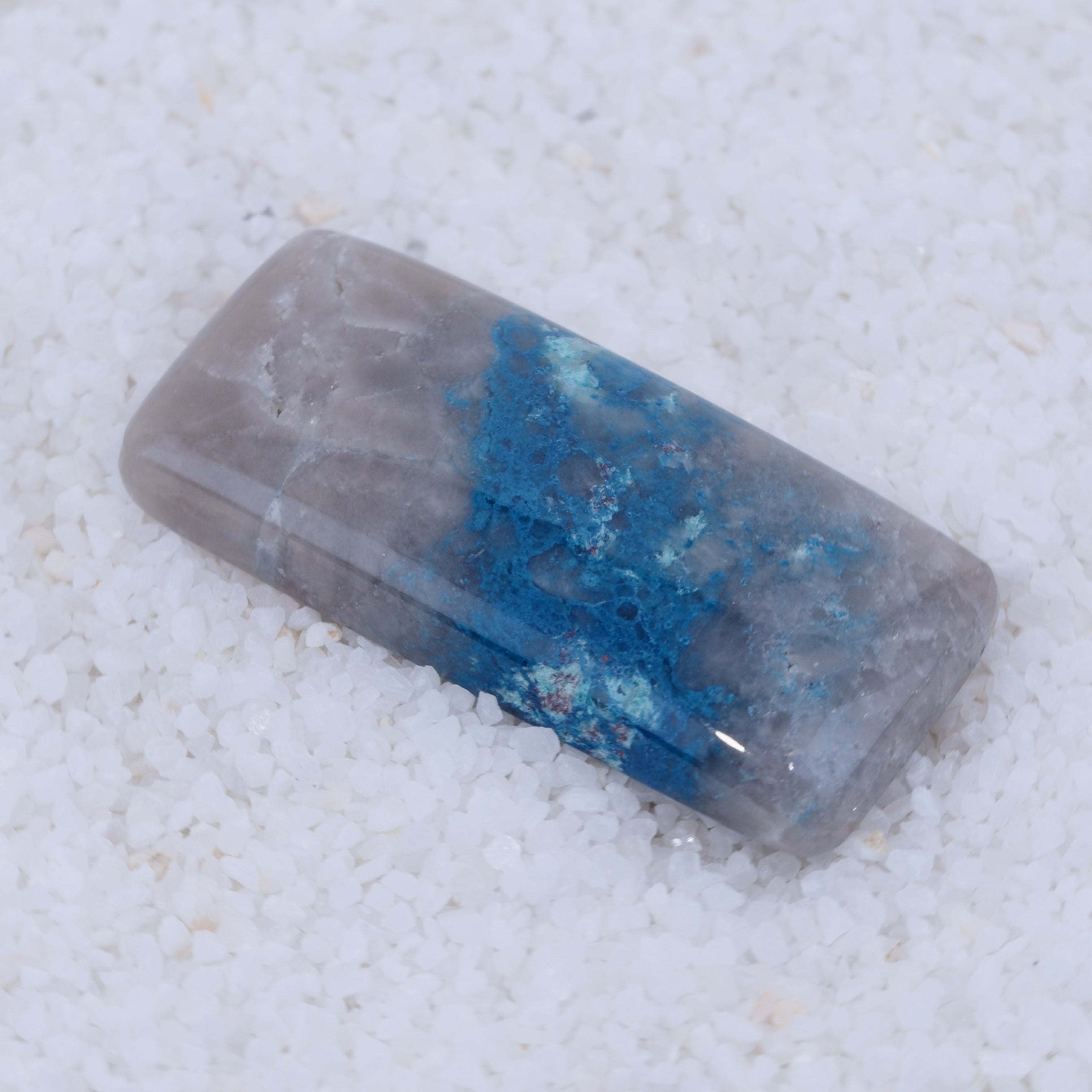 Rectangular crystal with blue and gray colors on a white background