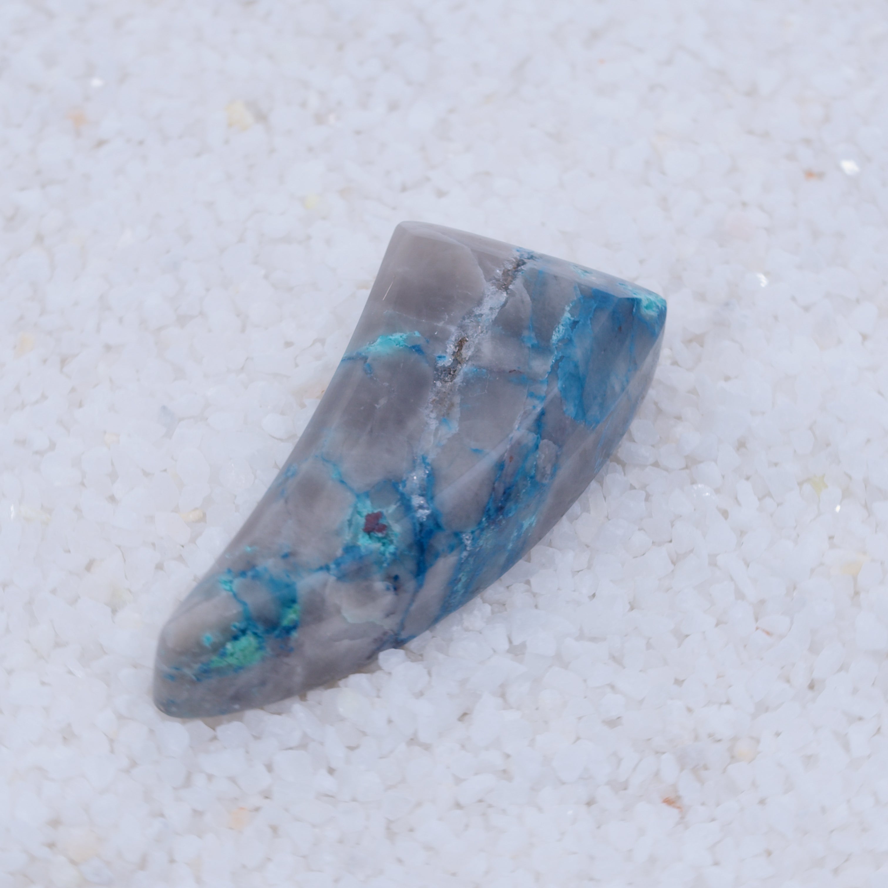 Canyonite crystal with blue veins on a white background