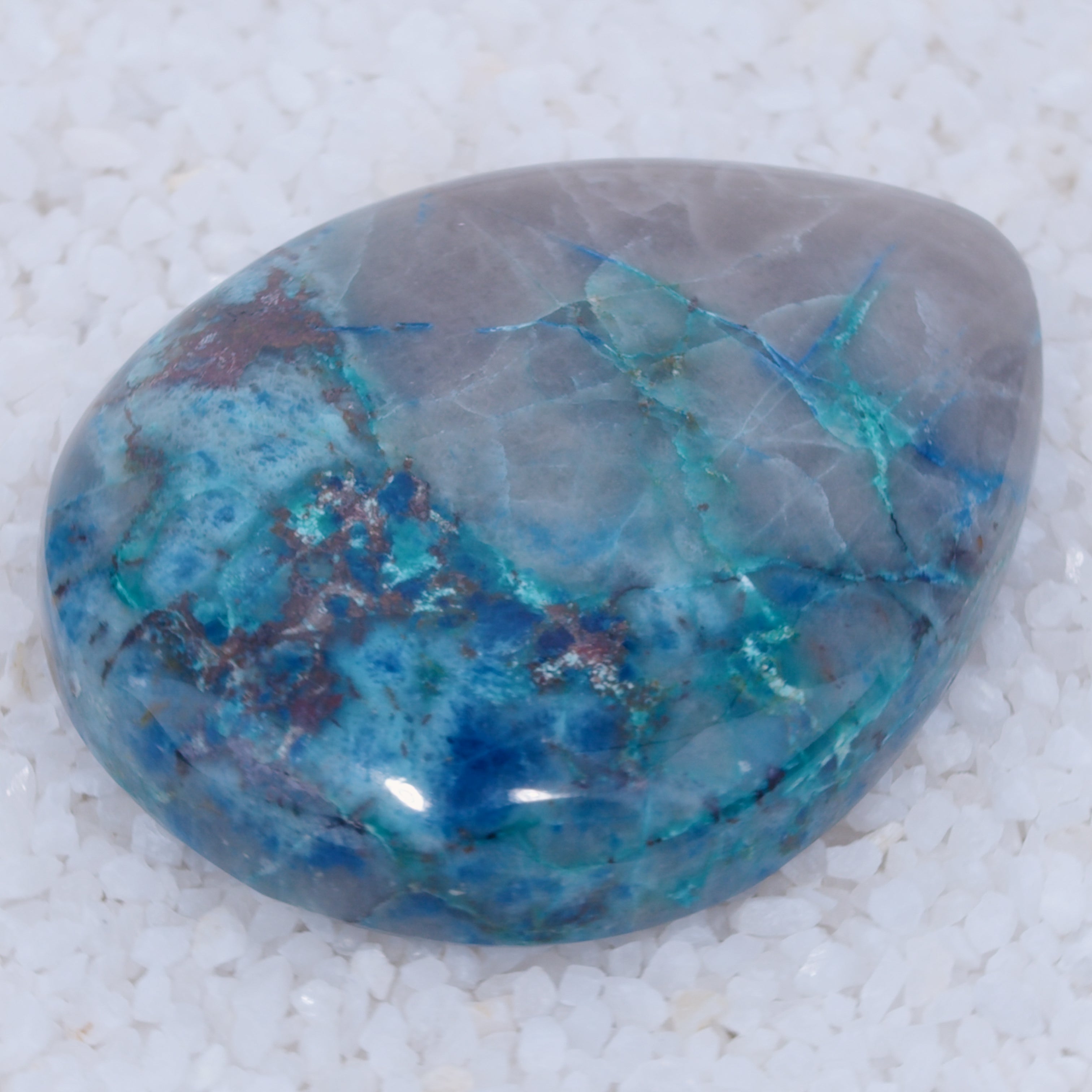 Polished canyonite blue and gray stone on a white background