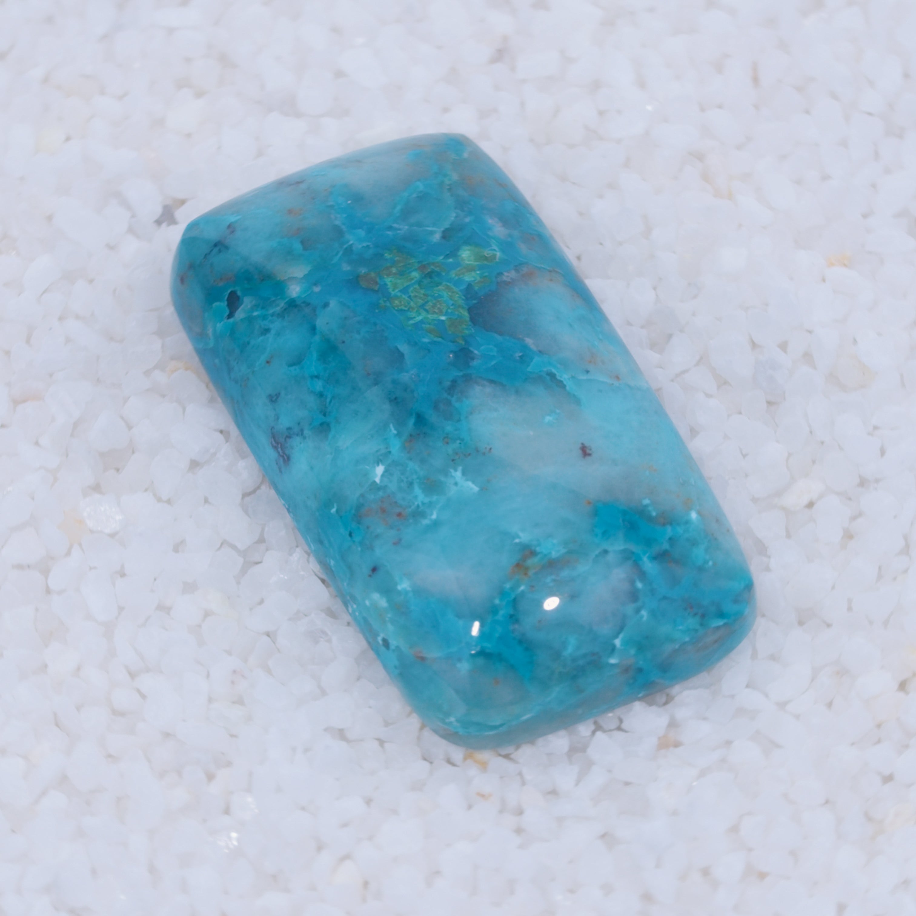Blue Canyonite stone on a textured white surface