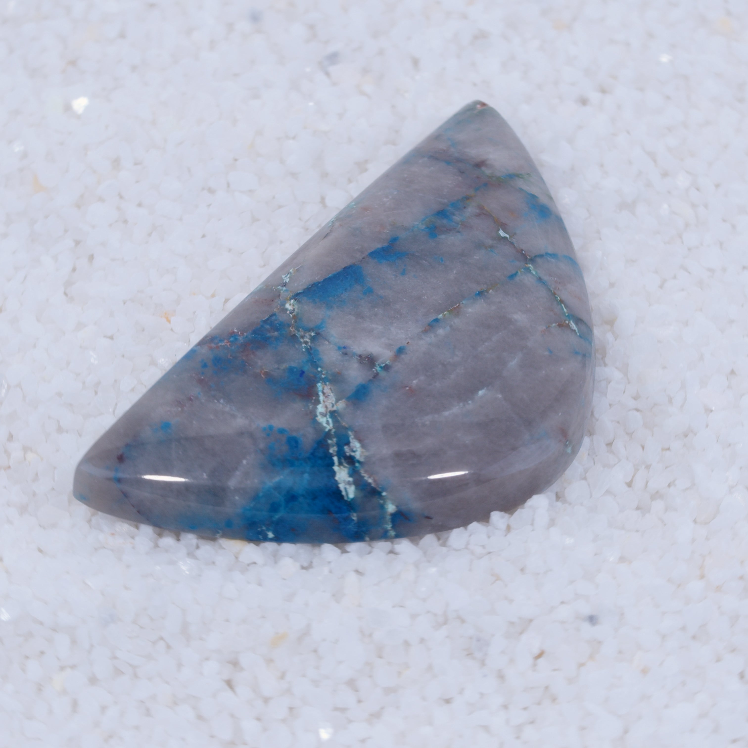 Triangular blue and gray stone on a white background