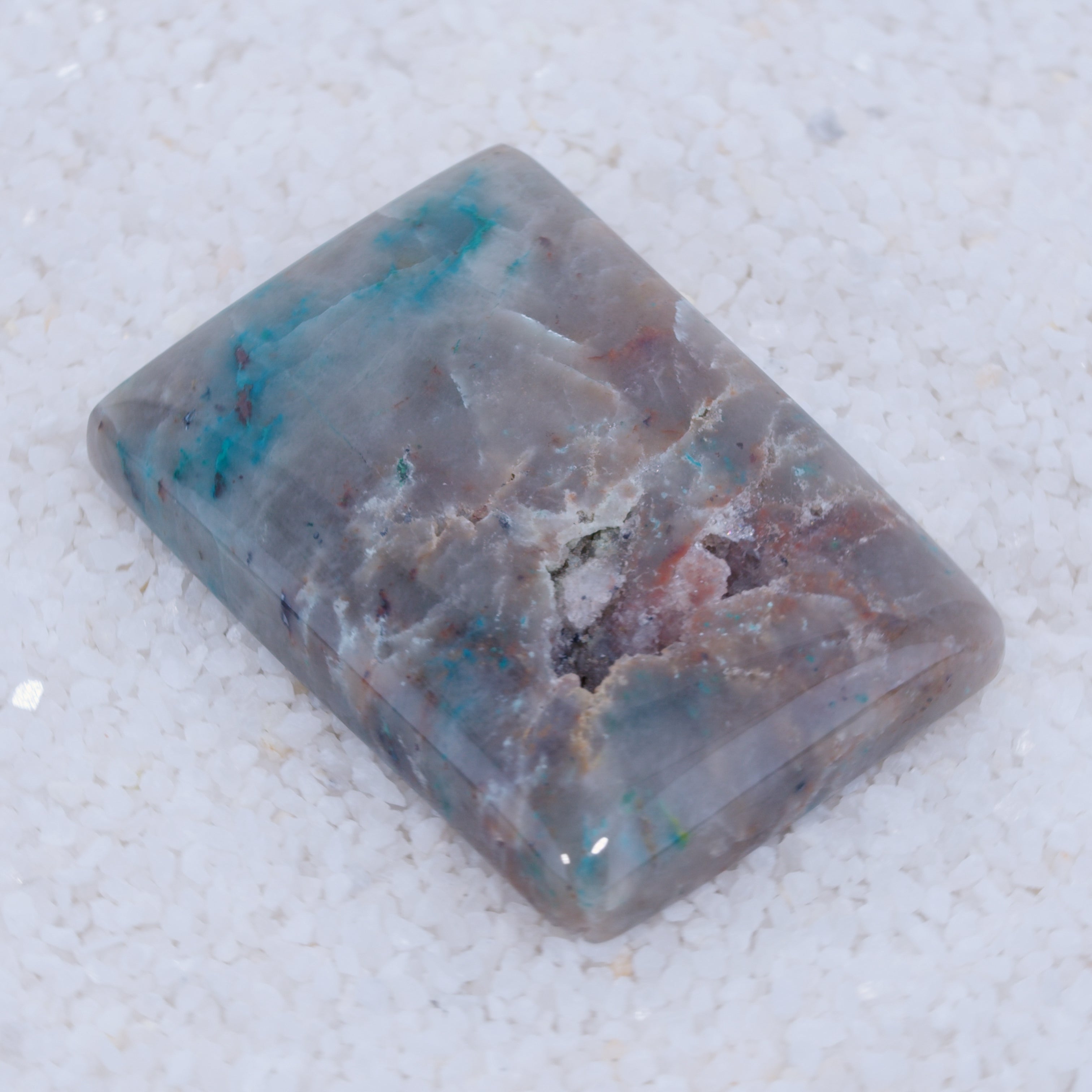 Rectangular stone with marbled pattern on a textured white background