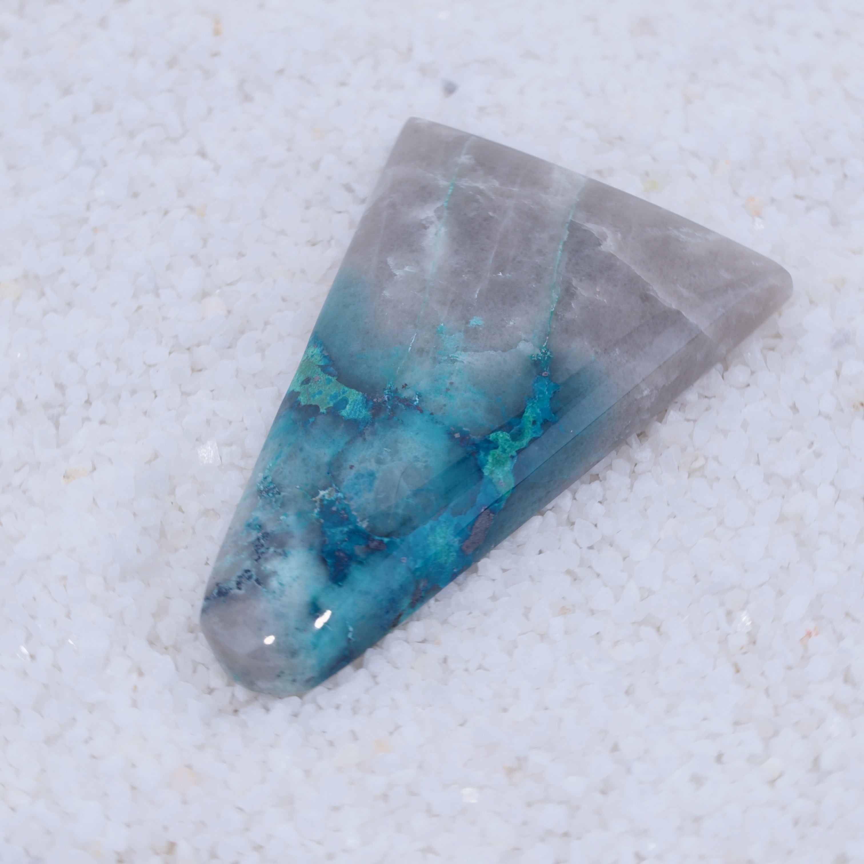 Geometric Canyonite crystal with blue and gray colors on a white background