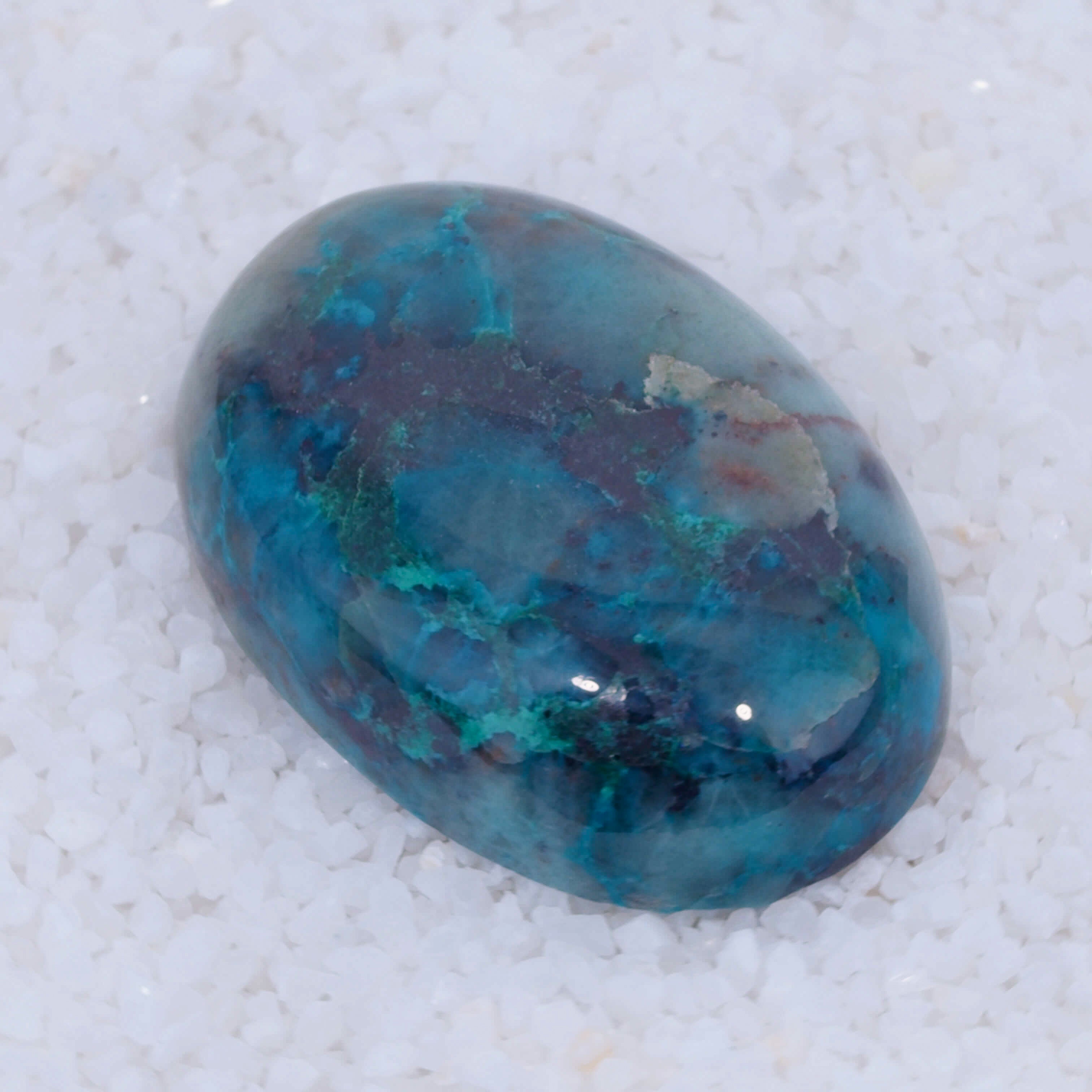 Blue and green marbled Canyonite stone on a white background