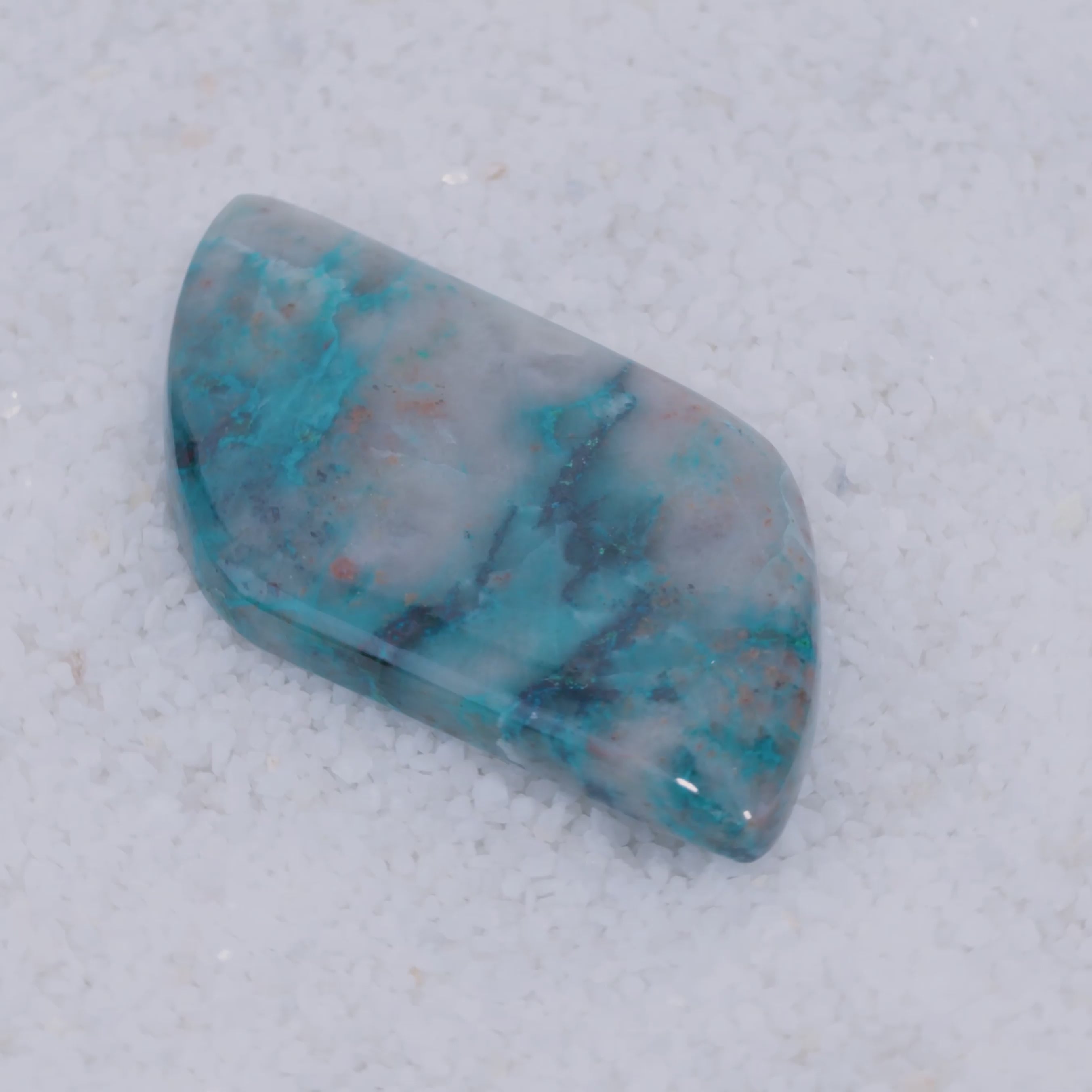 Polished Canyonite stone with blue and gray patterns on a white background