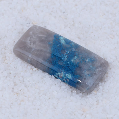 Rectangular crystal with blue and gray colors on a white background