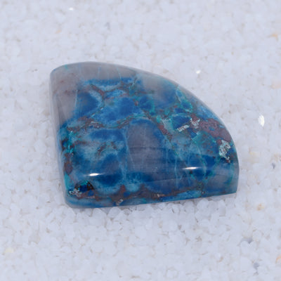 Blue and purple stone on a textured white background