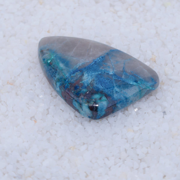 Blue and gray stone on a textured white background