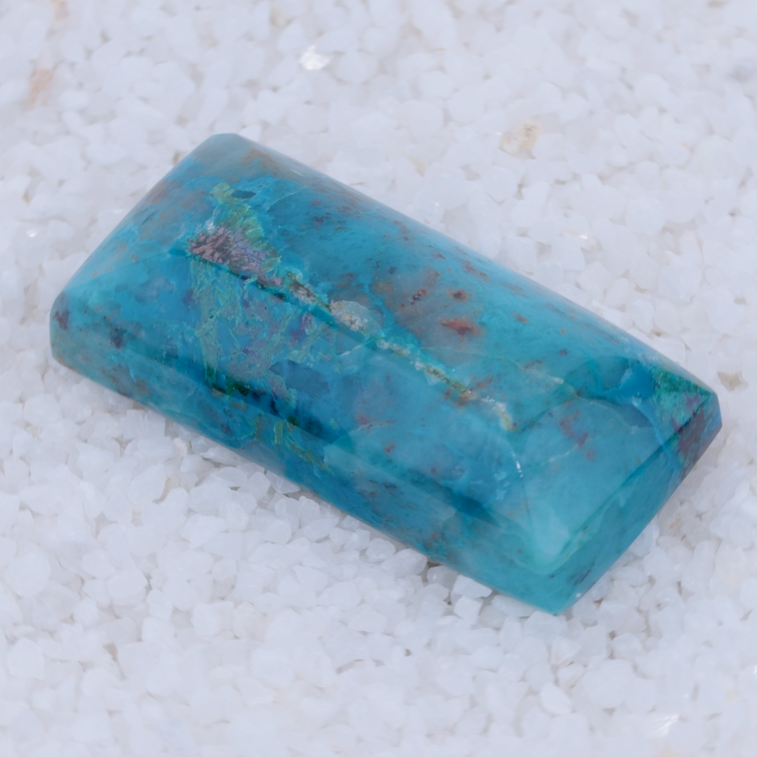 Blue stone on a textured white background