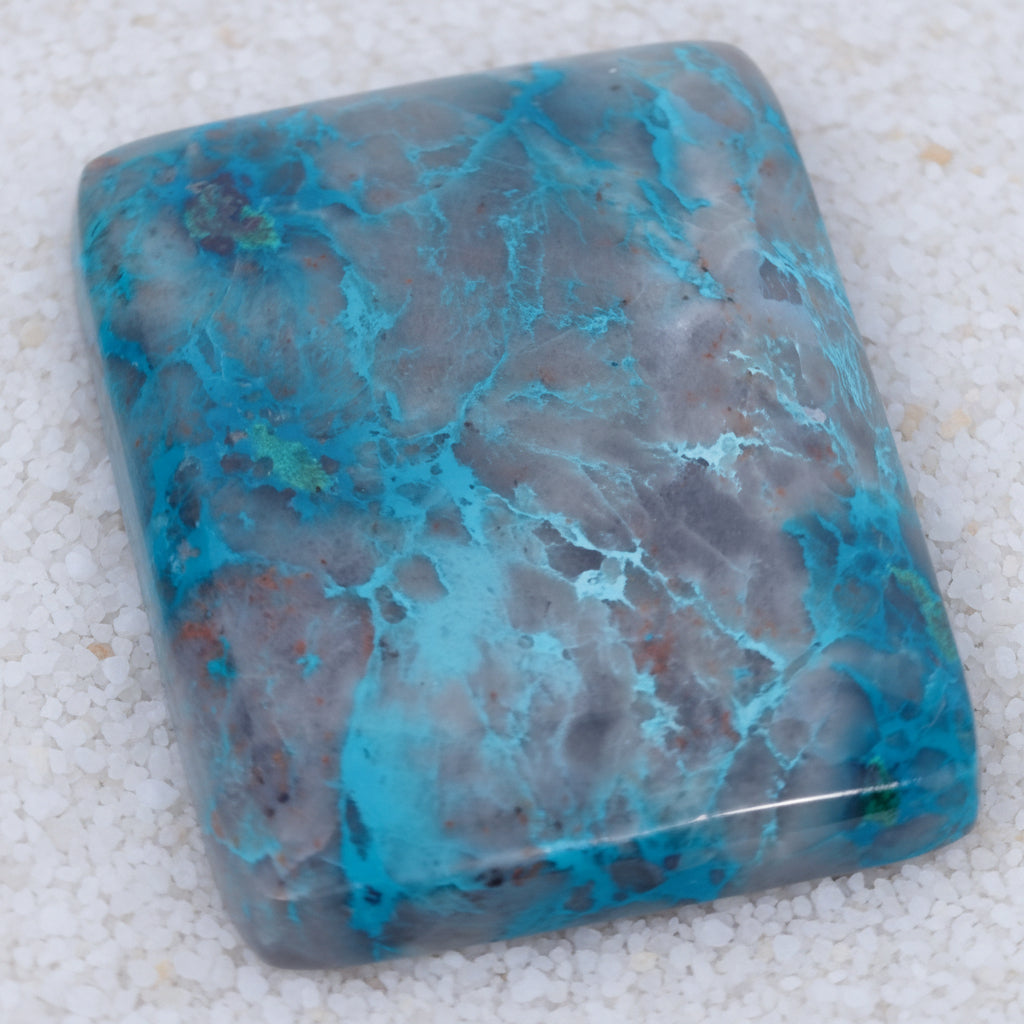 Turquoise stone with blue and gray patterns on a white background