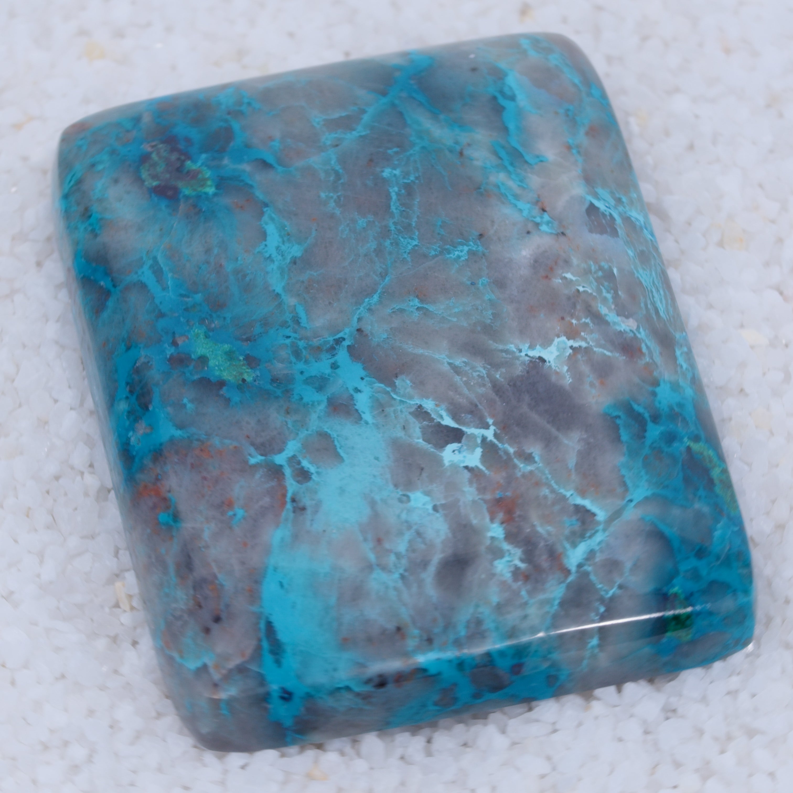 Turquoise stone with blue and gray patterns on a white background