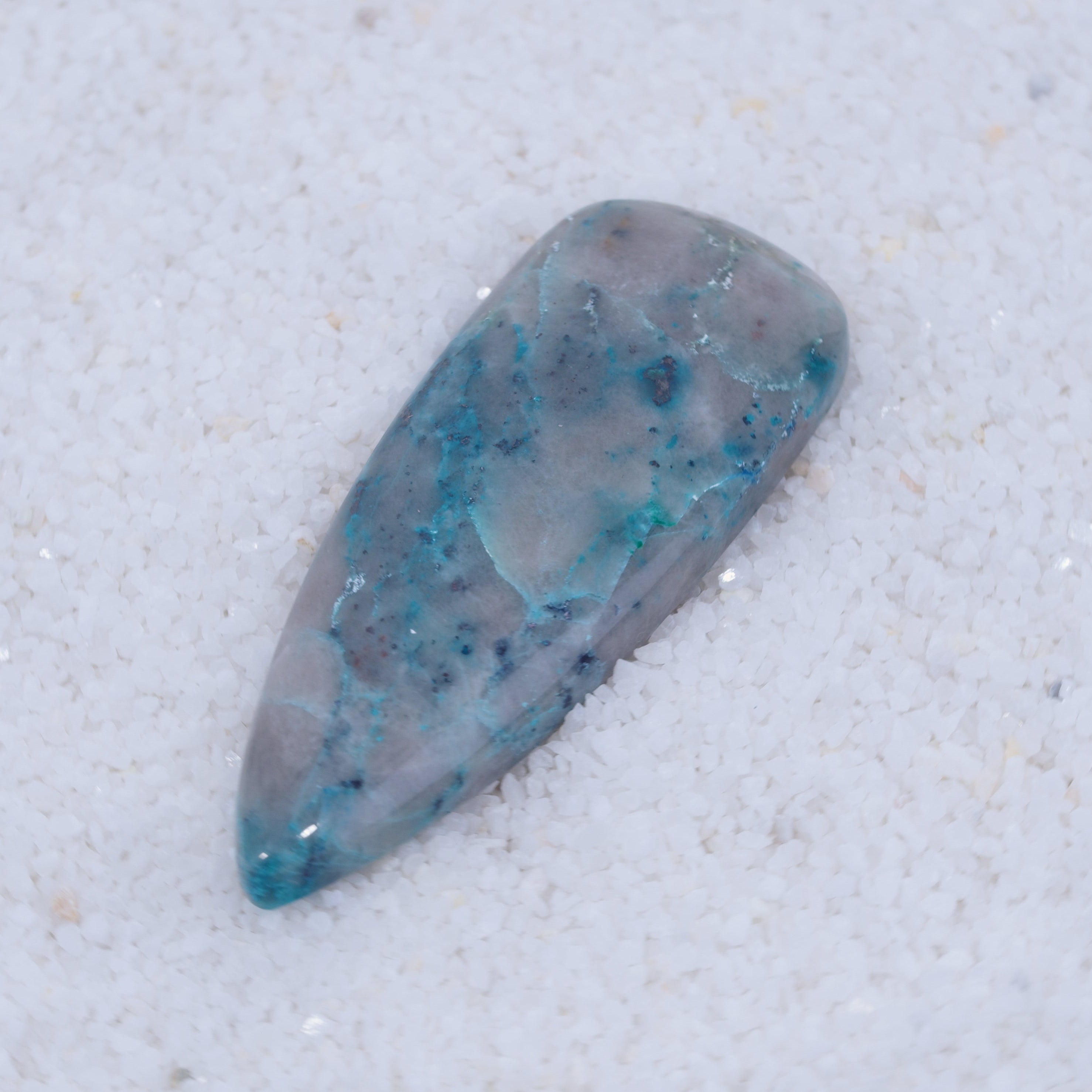 Blue and gray stone on a textured white background