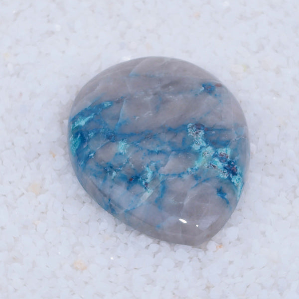 Polished stone with blue veins on a white background