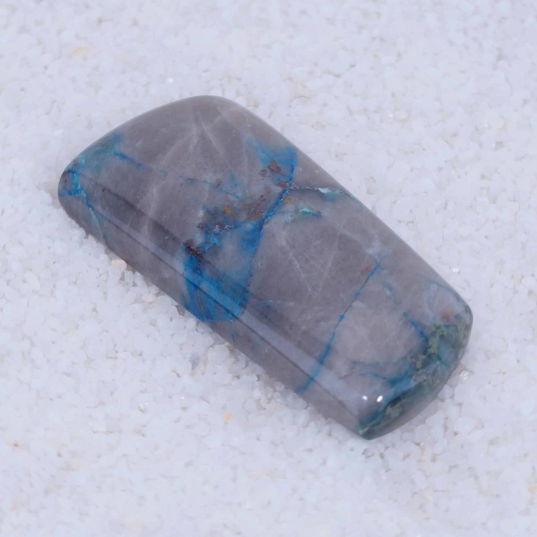 Dark blue Papagoite and Ajoite mineralization preserved in a polished Canyonite gemstone