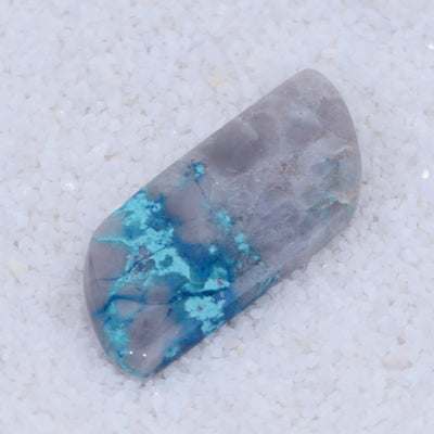 Polished Canyonite stone with blue and gray patterns on a white background