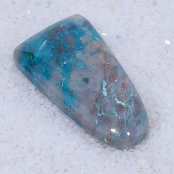 Polished Canyonite stone with blue and gray patterns on a white background