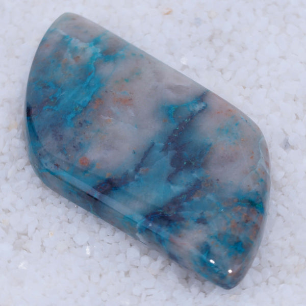 Polished Canyonite stone with blue and gray patterns on a white background