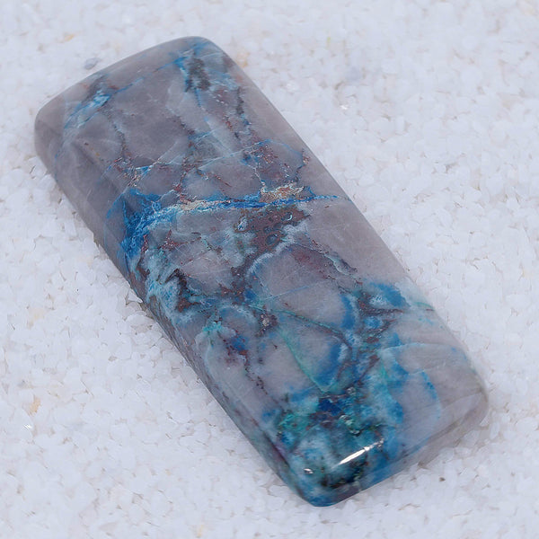 Polished stone with blue and gray patterns on a white background