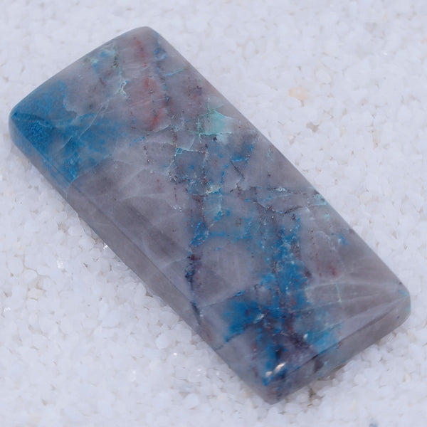 Polished Canyonite stone with blue and purple patterns on a white background