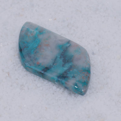 Polished Canyonite stone with blue and gray patterns on a white background